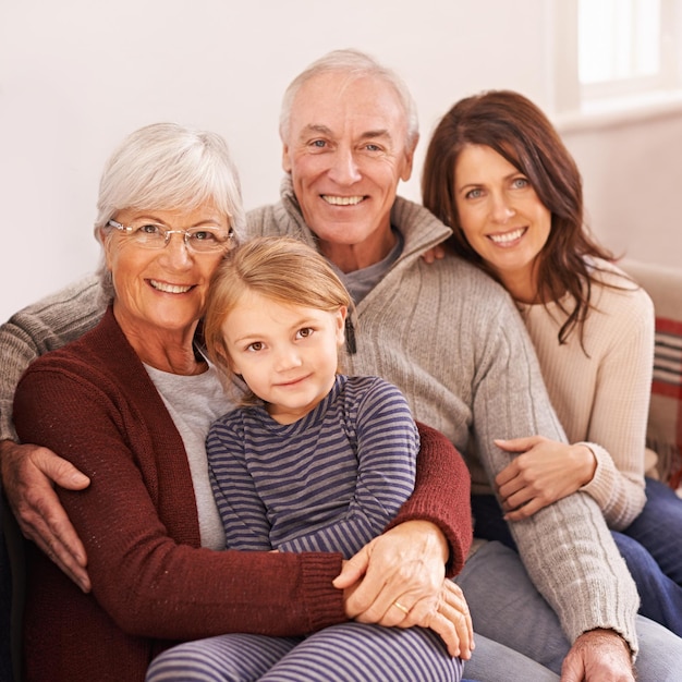 Photo you can feel the warmth of their love a cropped portrait of a happy multigeneration family sitting together on a sofa