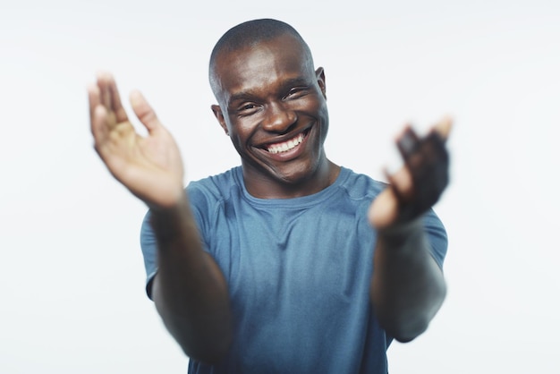 You deserve a round of applause well done Studio shot of a handsome young man clapping his hands against a grey background