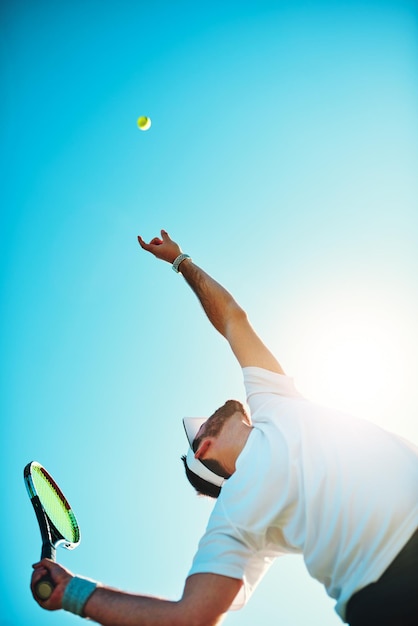 You got served low angle shot of a sporty young man playing tennis