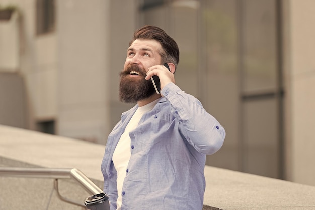 Do you hear me Bearded man use smartphone outdoors Mobile technology New technology Cellular technology Modern life Technology for communication