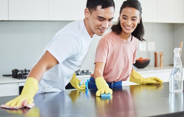 You make even the mundane exciting Shot of a young couple cleaning their kitchen together