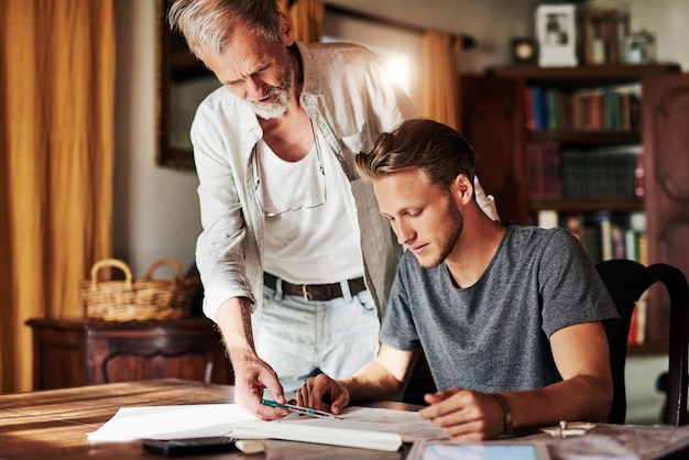 You might want to rethink this Shot of two men working on a project together at home