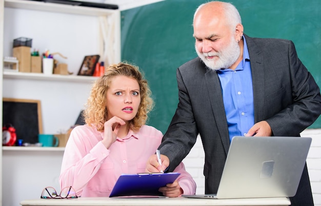 You must study brainstorming on new project working student and tutor with laptop pass exam teachers room student girl with tutor man at blackboard senior teacher and woman at school lesson