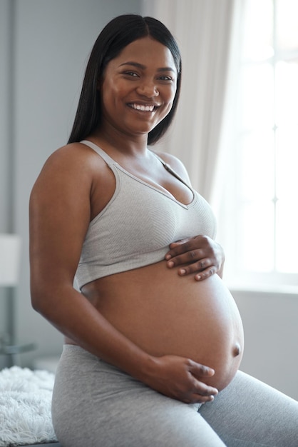 You never understand life until it grows inside of you Portrait of a pregnant woman at home