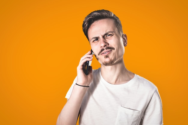 You will have problems man Portrait of angry confused aggressive  guy irritably speaks on the phone