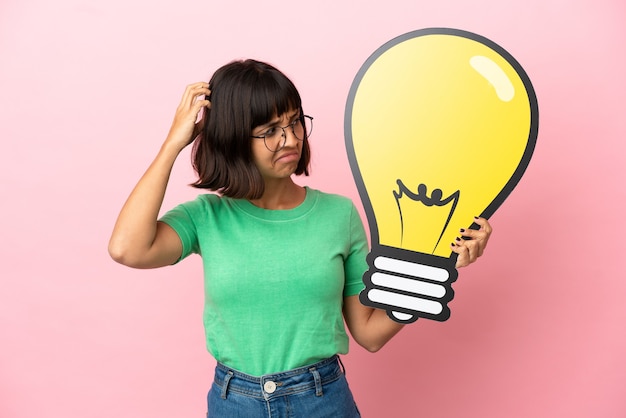 Youing woman holding a bulb icon and having doubts