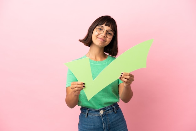 Youing woman holding a check icon with happy expression