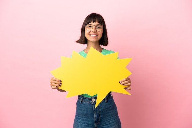 Youing woman holding an empty speech bubble