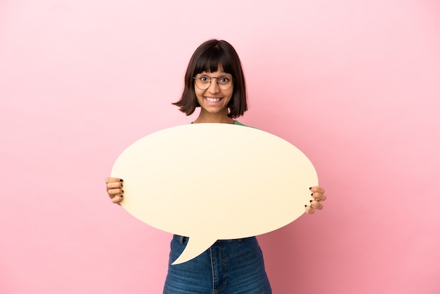 Youing woman holding an empty speech bubble