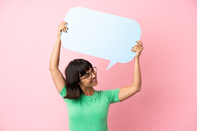 Youing woman holding an empty speech bubble