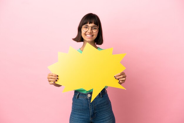 Youing woman holding an empty speech bubble