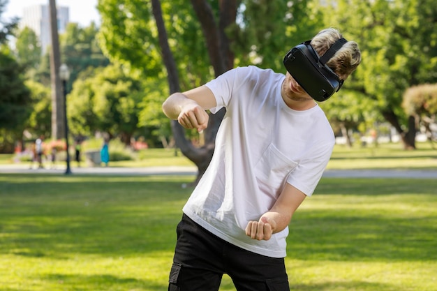 A youn amn wearing VR set and squeezed his fists at the park