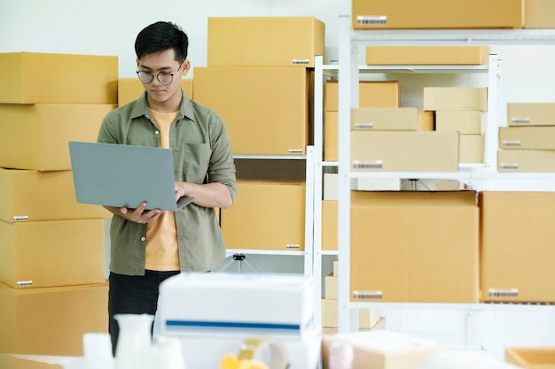 Youn male small business entrepreneur working on laptop