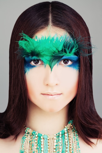 Yound Woman Fashion Model Face with Makeup and Feather