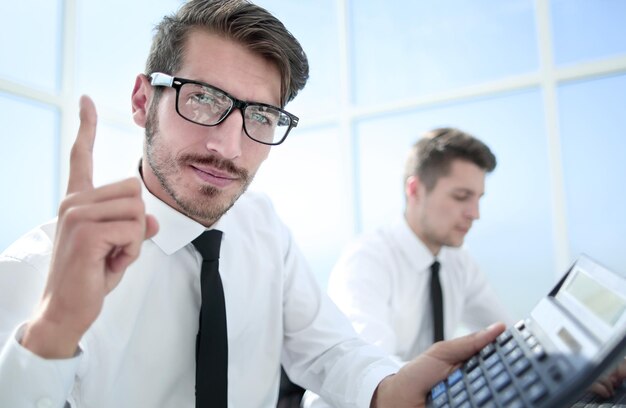 Young accountant holding a thumb up and smiling