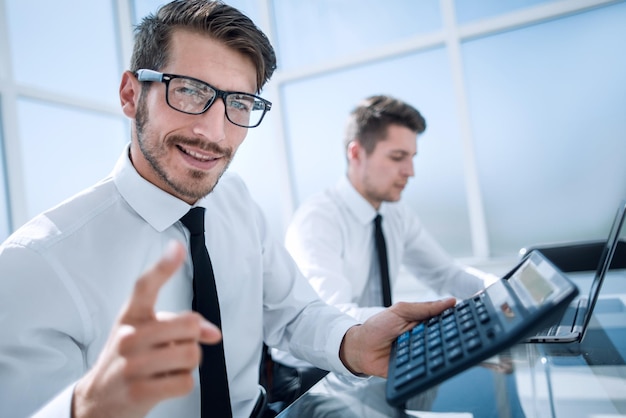 Young accountant holding a thumb up and smiling