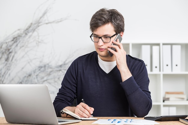 Young accountant on phone