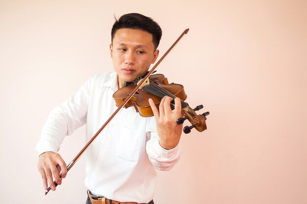 Young adult Asian man playing violin