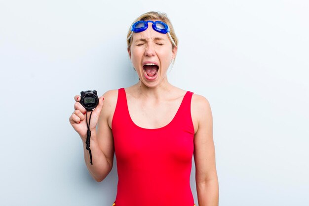 Young adult blonde woman swimmer concept