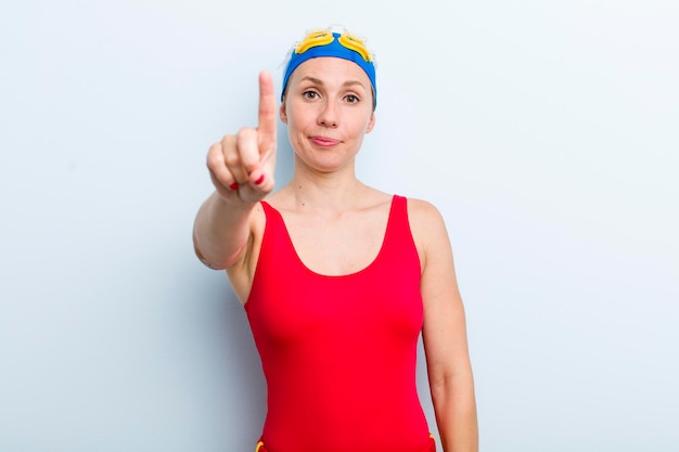 Young adult blonde woman swimmer and summer concept