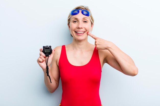 Young adult blonde woman swimmer and summer concept