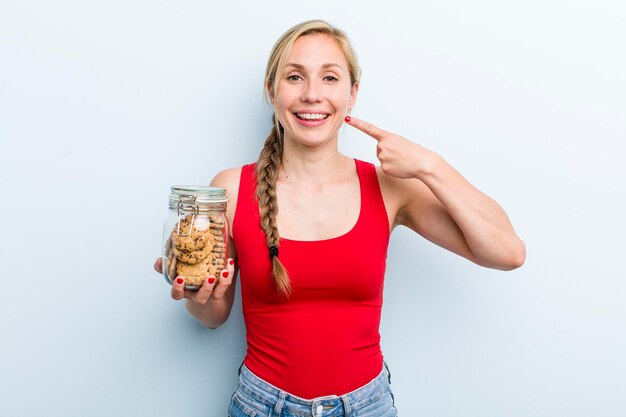 Young adult blonde woman with home made cookies