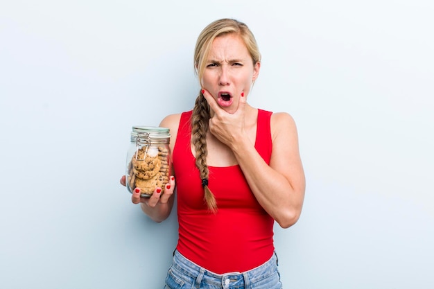 Young adult blonde woman with home made cookies