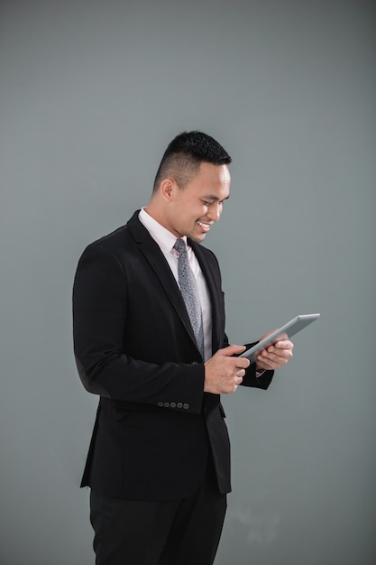 Young adult businessman with tablet