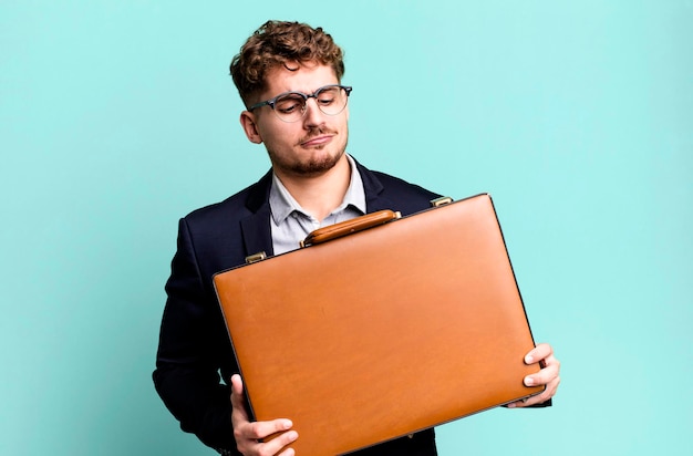 Young adult caucasian businessman with a suit case