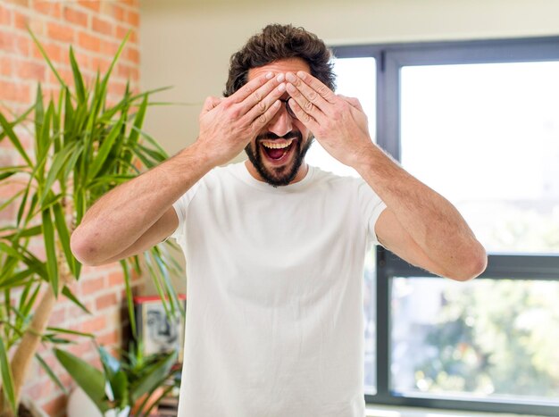 Young adult crazy man with expressive pose at a modern house interior