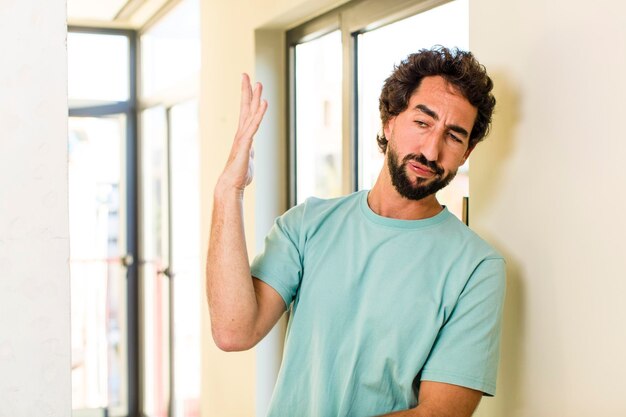 Young adult crazy man with expressive pose at a modern house interior