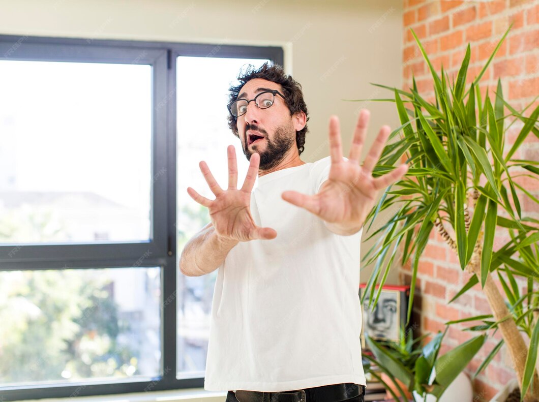 Young adult crazy man with expressive pose at a modern house interior