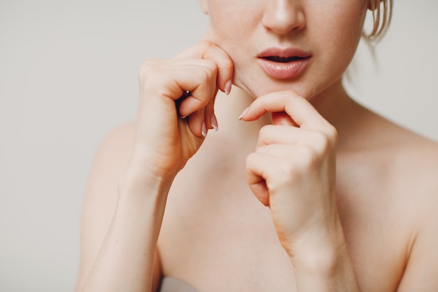 young adult doing face gymnastics self massage and rejuvenating exercises face building for skin and muscles lifting