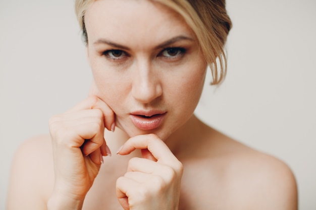 young adult doing facial gymnastics self massage and rejuvenating exercises face building for skin and muscles lifting