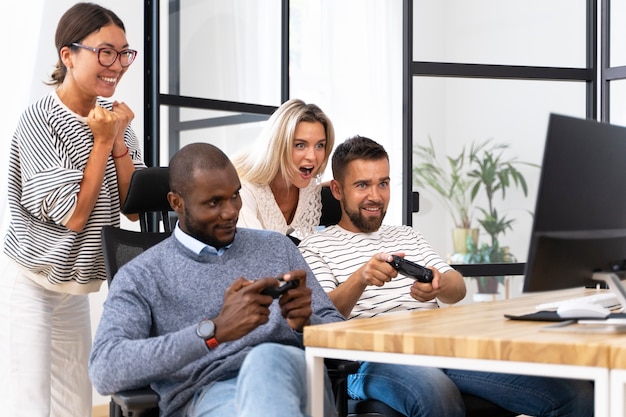 Photo young adult friends having fun while playing video games