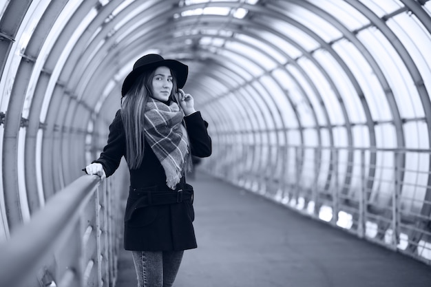 Young adult girl in the architectural tunnel of the bridge