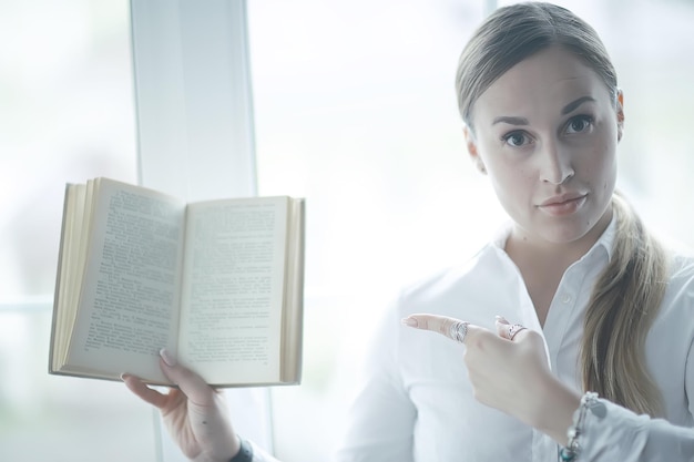 Young adult girl with book learning, reading, business