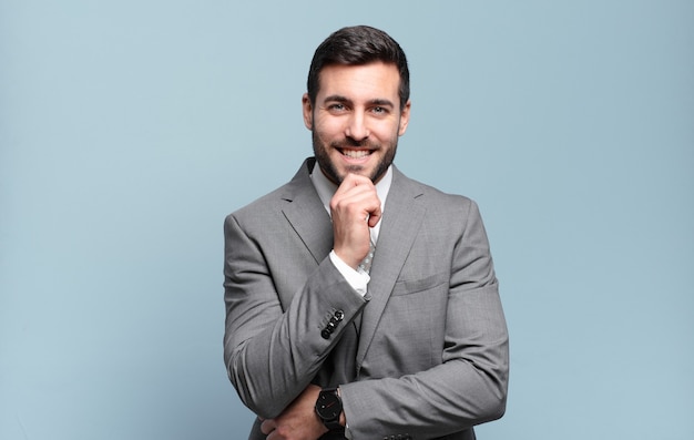 Young adult handsome businessman looking happy