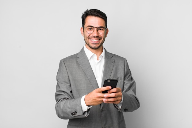 Young adult handsome hispanic man business concept with a mobile phone