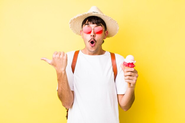 Young adult handsome man with an ice cream summer concept