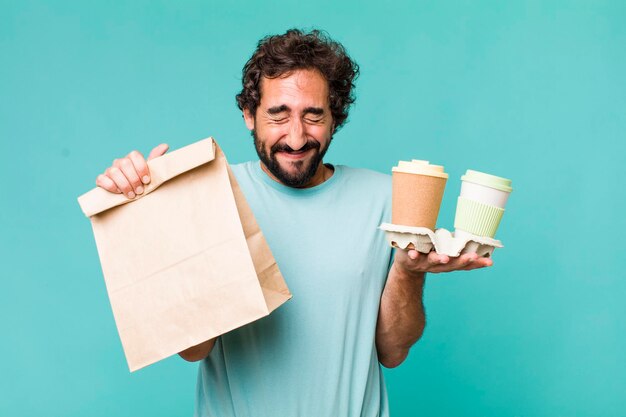 Young adult hispanic crazy man delivery take away coffees concept