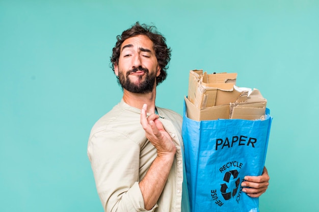 Young adult hispanic crazy man recycling an ecology concept