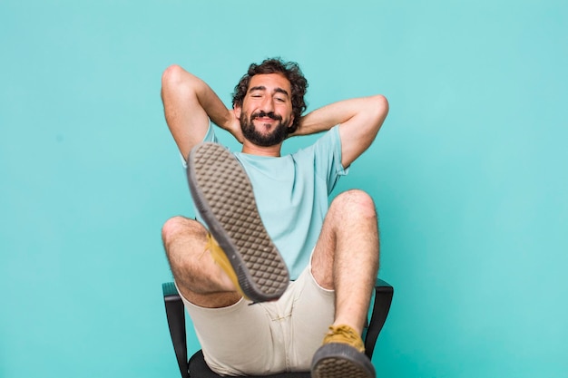 Young adult hispanic crazy man sitting on a chair