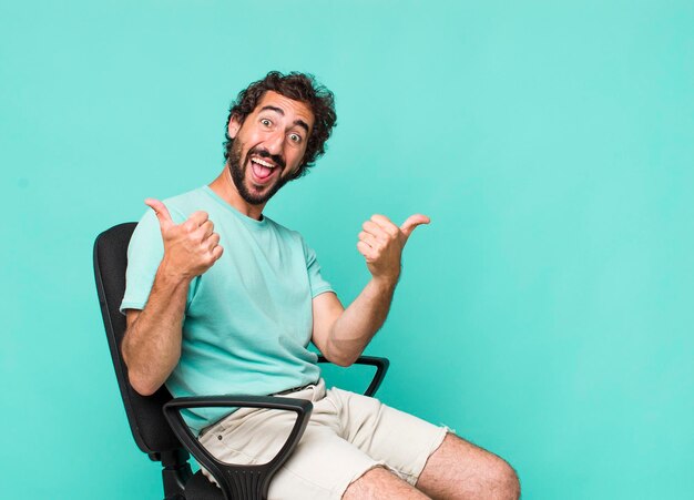 Young adult hispanic crazy man sitting on a chair