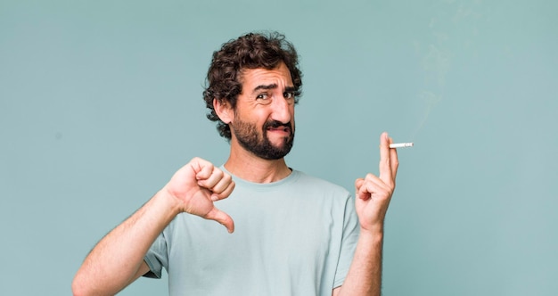 Young adult hispanic crazy man with a cigarette