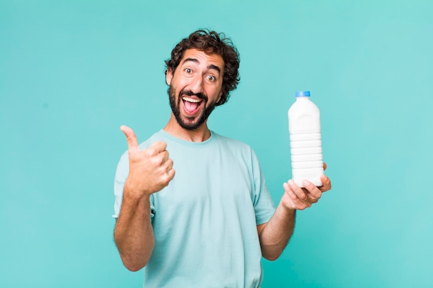 Young adult hispanic crazy man with a milk bottle