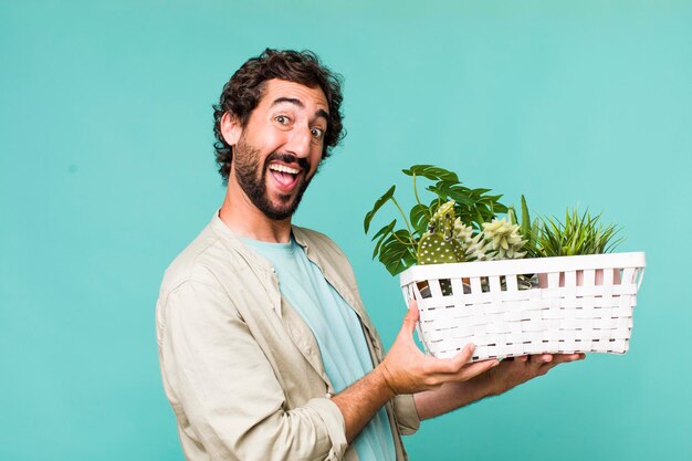 Young adult hispanic crazy man with plants gardering concept