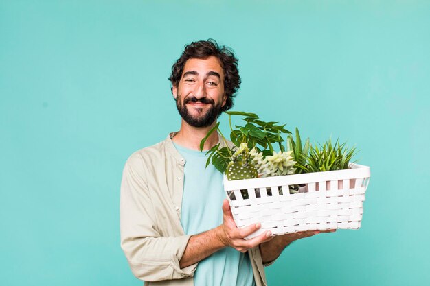 Young adult hispanic crazy man with plants gardering concept