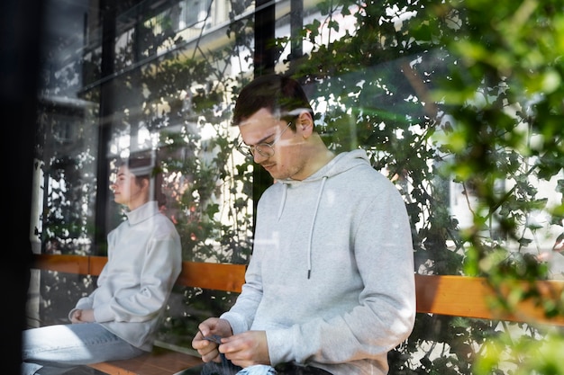 Young adult knitting outside