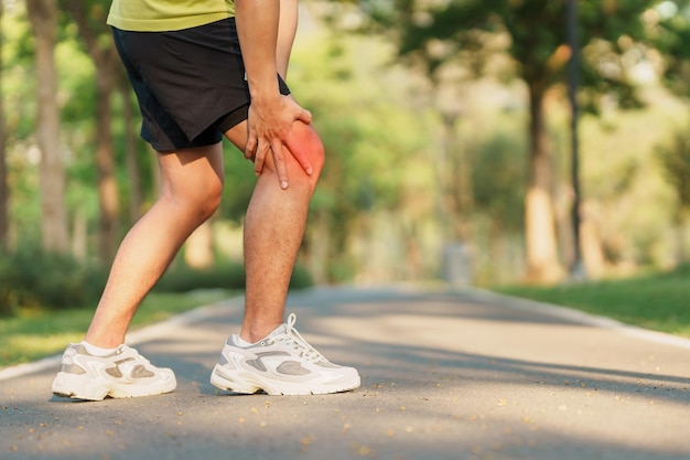 Young adult male with muscle pain during running runner have knee ache due to runners knee or patellofemoral pain syndrome osteoarthritis and patellar tendinitis sports injuries and medical concept